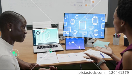 Image of ecology icons over diverse female colleagues discussing work in office 126441279