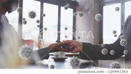 Image of virus cells over african american woman paying with smartphone 126441363
