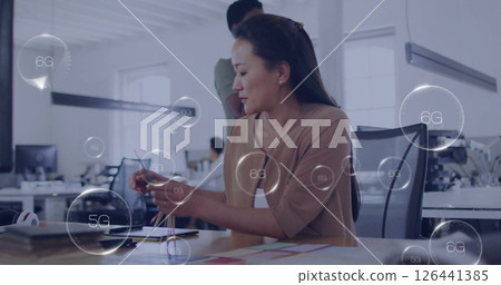 Working in modern office, woman surrounded by 5G and 6G network image 126441385