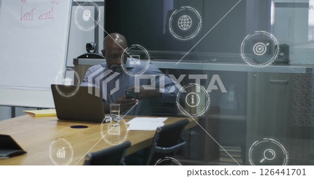 Image of digital icons over african american businessman in office Image of digital icons over african american businessman in office 126441701