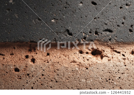 Close-Up Texture of Brown and Black Porous Material 126441932