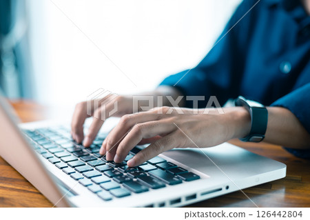Woman sits at table, using her mobile phone to navigate social media and conduct business through latest technology in cyberspace. social media, table, mobile phone, technology, person, cyberspace. Woman sits at table, using her mobile phone to navigate social media and conduct business through latest technology in cyberspace. social media, table, mobile phone, technology, person, cyberspace. 126442804