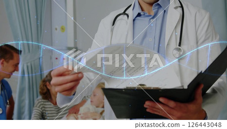 Image of dna strand over caucasian male doctor reading documents Image of dna strand over caucasian male doctor reading documents 126443048