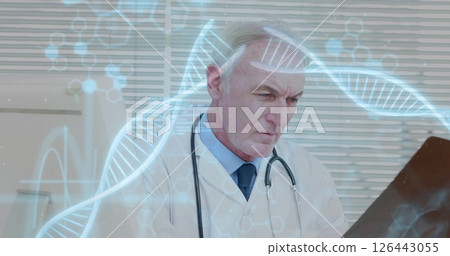 Image of dna strands with data processing over caucasian male doctor reading x-ray scan 126443055