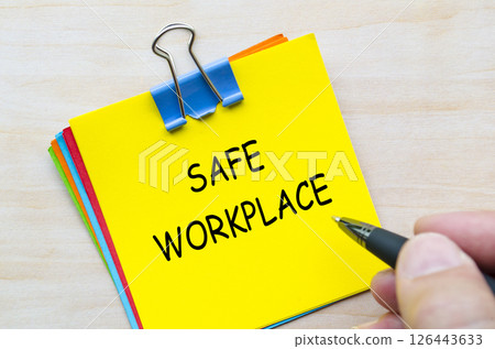 Safe workplace text on yellow sticky notes representing commitment to employee protection and safety. Safe workplace text on yellow sticky notes representing commitment to employee protection and safety. 126443633