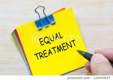 Equal treatment text on yellow sticky notes representing fairness and non-discrimination for all 126443637