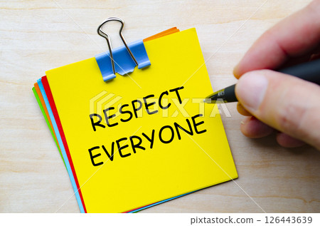 Respect everyone text on yellow sticky notes representing equality and kindness in daily interactions Respect everyone text on yellow sticky notes representing equality and kindness in daily interactions 126443639