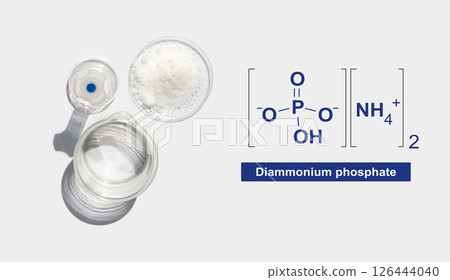 Chemical ingredient on white laboratory table with molecular structure. Di-Ammonium Phosphate in chemical watch glass place next to beaker with alcohol and Volumetric flask. Top View 126444040