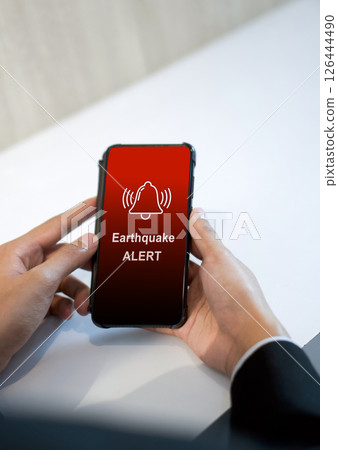 Earthquake alert warning displayed on smartphone screen as symbol, telling people to be careful. Technology concept Earthquake alert warning displayed on smartphone screen as symbol, telling people to be careful. Technology concept 126444490