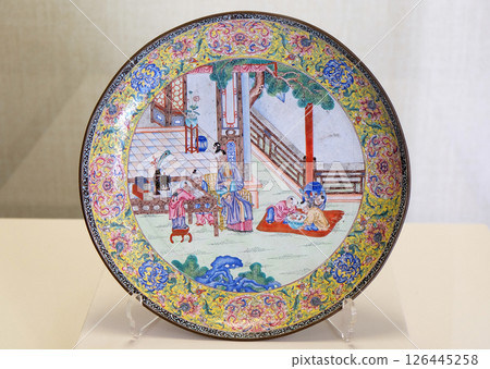 Painted enamel round plate with designs of beatiful ladies and five children from Qing Dynasty in Forbidden City, Beijing 126445258