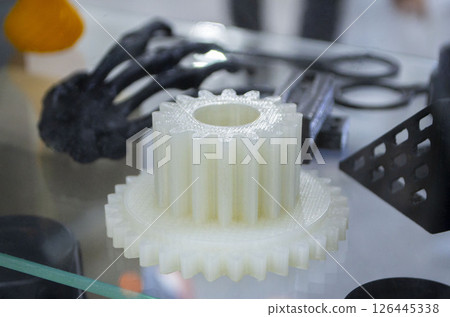 Models printed on 3D printer from molten plastic white color. Model of part created on 3D printer from white plastic. Concept 3D printer 3D printing modeling prototyping three dimensional object Models printed on 3D printer from molten plastic white color. Model of part created on 3D printer from white plastic. Concept 3D printer 3D printing modeling prototyping three dimensional object 126445338