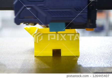 The process of printing an object with 3D printer. 3D printer printing a model from molten plastic. 3D printing. Robotic creation of mold form. Automated creation prototyping of 3D printers technology The process of printing an object with 3D printer. 3D printer printing a model from molten plastic. 3D printing. Robotic creation of mold form. Automated creation prototyping of 3D printers technology 126445407