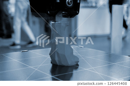 The process of printing an object with 3D printer. 3D printer printing a model from molten plastic. 3D printing. Robotic creation of mold form. Automated creation prototyping of 3D printers technology The process of printing an object with 3D printer. 3D printer printing a model from molten plastic. 3D printing. Robotic creation of mold form. Automated creation prototyping of 3D printers technology 126445408