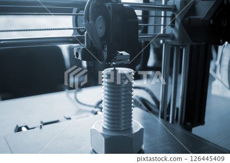 The process of printing on a 3D printer. 3D printer printing object from molten plastic close-up. Creative creation of model on 3D printer. New modern technologies of 3D printing. Additive technology The process of printing on a 3D printer. 3D printer printing object from molten plastic close-up. Creative creation of model on 3D printer. New modern technologies of 3D printing. Additive technology 126445409
