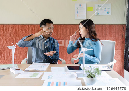 ESG Collaboration. Professionals brainstorming on renewable energy solutions in a modern office. ESG Collaboration. Professionals brainstorming on renewable energy solutions in a modern office. 126445778