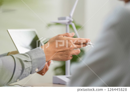 ESG Consultation. Professional discussing sustainable business practices with client. 126445828