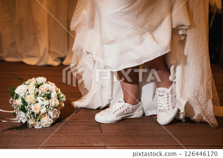 Bride Wearing Sneakers and Standing Next to Bouquet 126446170