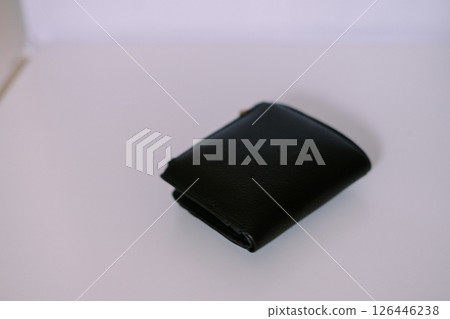 Close-up view of a sophisticated black leather wallet on neutral backdrop Close-up view of a sophisticated black leather wallet on neutral backdrop 126446238