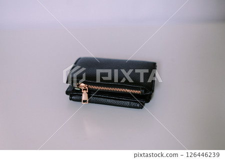 Close-up view of a sophisticated black leather wallet on neutral backdrop 126446239