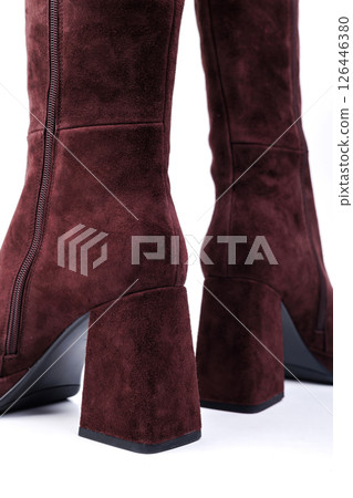 Stylish women's suede ankle boots with red heels with square toes on a white background. Winter leather women's shoes with elegant heels and buckles. Stylish women's suede ankle boots with red heels with square toes on a white background. Winter leather women's shoes with elegant heels and buckles. 126446380