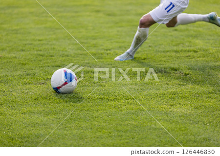 Football players at the stadium with the ball score a goal to the goalkeeper 126446830
