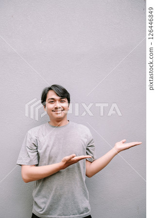 composite image of smiling asian man pointing 126446849