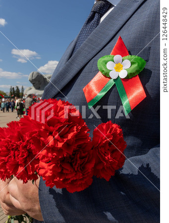 Man in blue suit with red carnations and apple flower ribbon during Belarus Independence Day in Brest 126448429