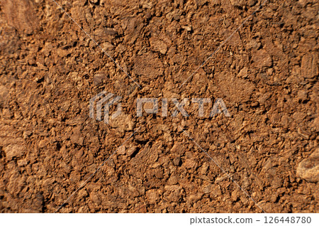Close-up with shallow depth of field. Surface of pressed cork wood. Orange warm background 126448780