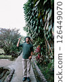 man taking photo with smartphone in garden 126449070