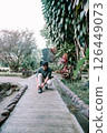 little girl sitting on the bench 126449073