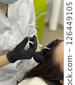 Trichologist giving injection to patient in clinic, closeup. Space for text. Medical aesthetic concept 126449105