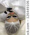 Carbon face peeling procedure. Laser pulses clean skin of the face.  126449106