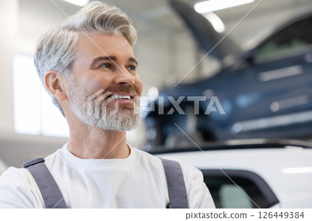 Mechanic with arms crossed near vehicle Mechanic with arms crossed near vehicle 126449384