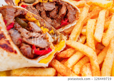 meat kebab wrapped in tortilla and French fries, selective focus 126449719