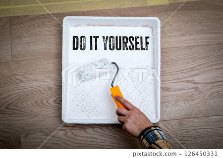 Do It Yourself. Paint Roller and Tray on Wooden Floor Background 126450331