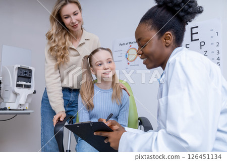 Fair-haired girl and her mom having consultation at the ophthalmologist office 126451134
