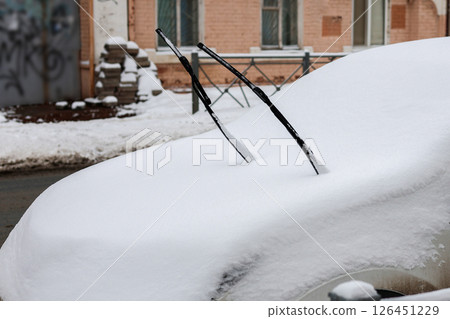 Raised windshield wipers prevent freezing to the glass in winter weather 126451229
