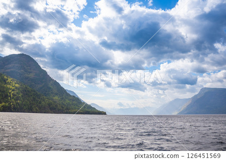 Early morning landscape of Teletskoye lake in Altai Russia. Calm water, soft light and serene mountain atmosphere near Artybash 126451569