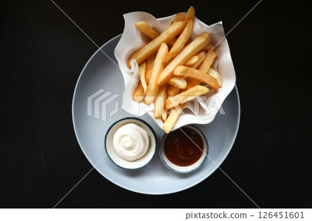 French fries or fried potato , fries with keychup and cheese dip French fries or fried potato , fries with keychup and cheese dip 126451601