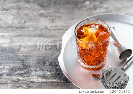 Americano cocktail garnished with twist orange on wooden table 126451892