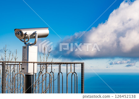 coin binocular on blue sky background 126452138