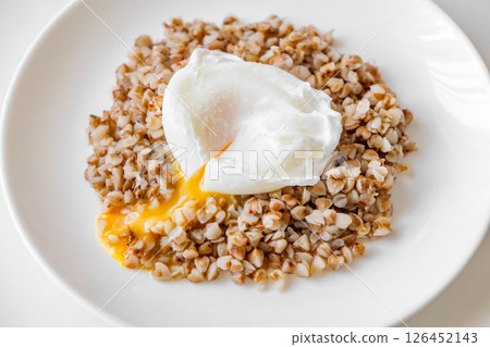 poached egg on boiled buckwheat porridge 126452143