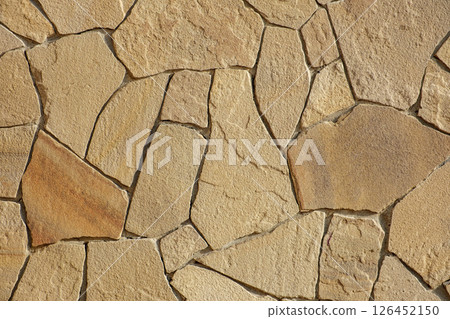 wall lined with flat stones of irregular shape 126452150