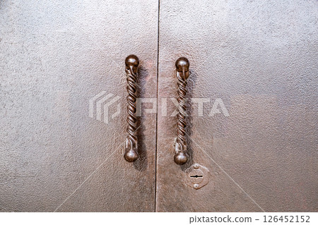 curly handles on painted metal gates 126452152