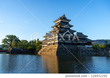 Matsumoto Castle reflecting in the water at sunset, Japan 126452292