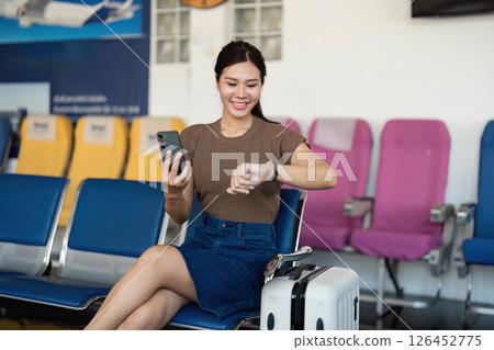 Traveling preparations with smartphone and watch at the airport 126452775