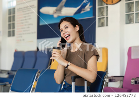 Travel day at the airport with woman enjoying coffee 126452778