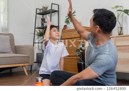 Family bonding through playful fitness activities at home 126452800