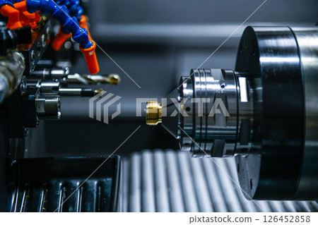 The CNC lathe machine thread cutting the screw metal shaft parts The CNC lathe machine thread cutting the screw metal shaft parts 126452858