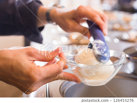 Ice cream stand with scoop on the background of refrigerated display case Ice cream stand with scoop on the background of refrigerated display case 126453276
